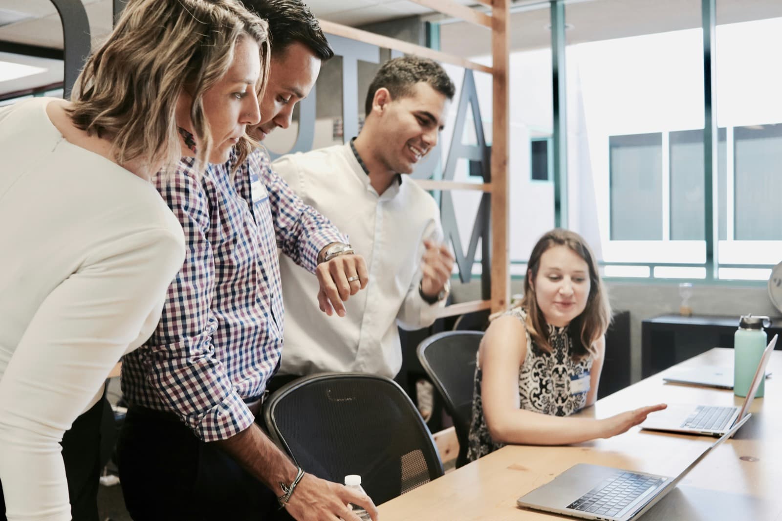Colleagues reviewing member benefits together at a laptop